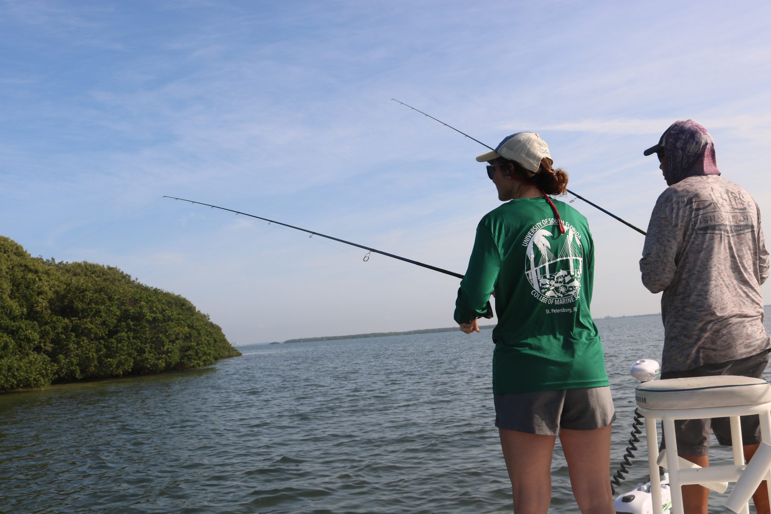 Tampa Bay Surveillance graduate student Kylee and charter captain fishing in Tampa Bay