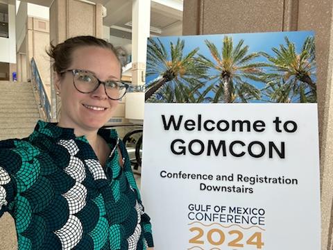 Dr. O'Leary (wearing her best fish-scale dress) at GOMCON 2024, ready to distribute surveys 