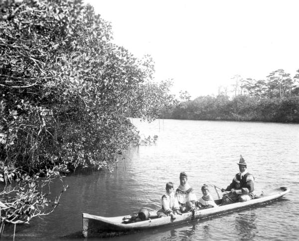 Seminole Indians in a dugout canoe